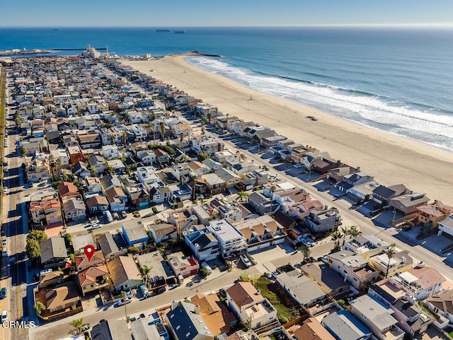 drone / aerial view featuring a view of the beach and a water view