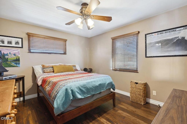 bedroom featuring ceiling fan, baseboards, and wood finished floors