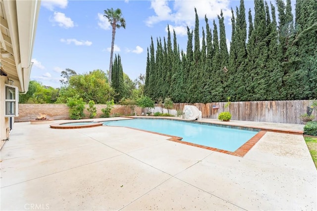 view of pool featuring a patio area, a fenced backyard, a fenced in pool, and an in ground hot tub