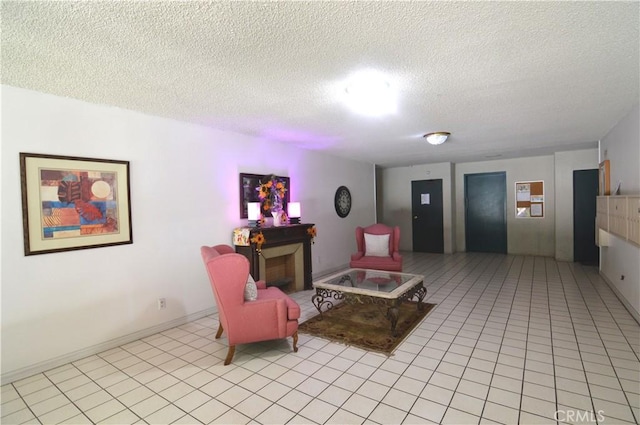 interior space featuring elevator, a textured ceiling, and light tile patterned floors