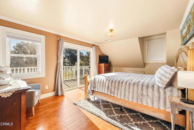 bedroom featuring ornamental molding, vaulted ceiling, access to outside, baseboards, and hardwood / wood-style flooring