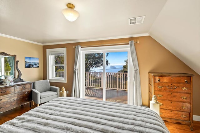 bedroom featuring access to exterior, visible vents, ornamental molding, vaulted ceiling, and wood finished floors