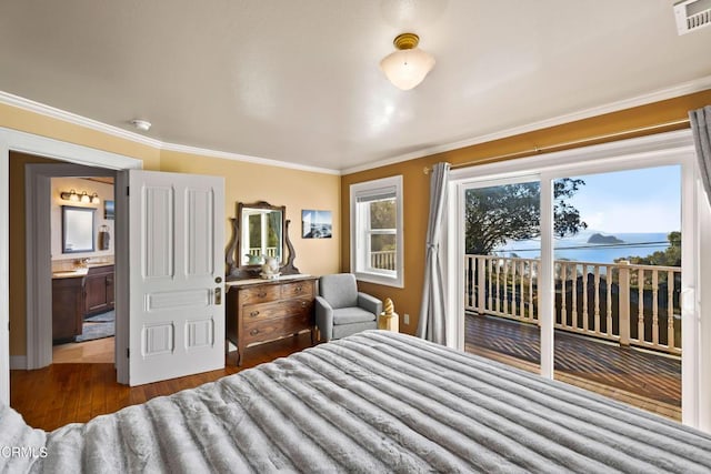 bedroom with crown molding, dark wood-style floors, visible vents, and access to exterior