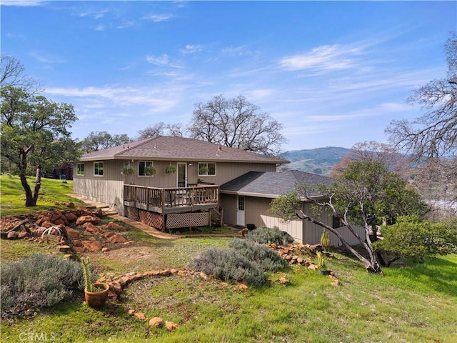 back of house featuring a yard and a wooden deck