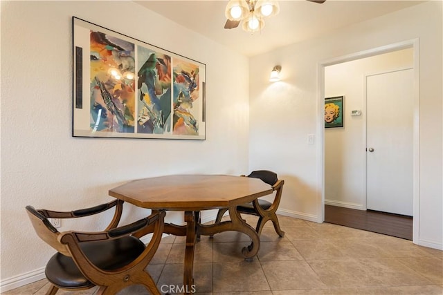 dining room featuring ceiling fan, baseboards, and tile patterned floors