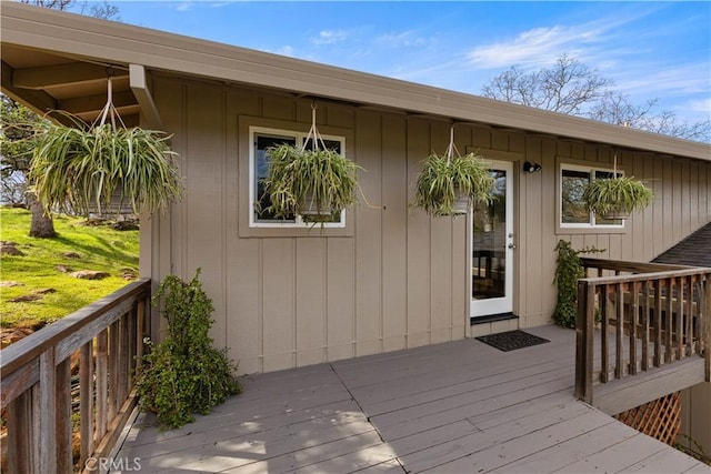 view of exterior entry featuring a wooden deck