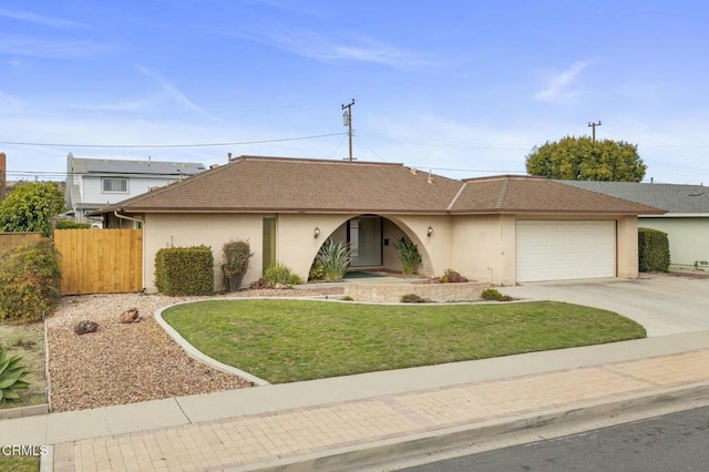 ranch-style house with an attached garage, fence, driveway, stucco siding, and a front yard