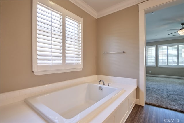 full bathroom with a ceiling fan, wood finished floors, a bath, and crown molding