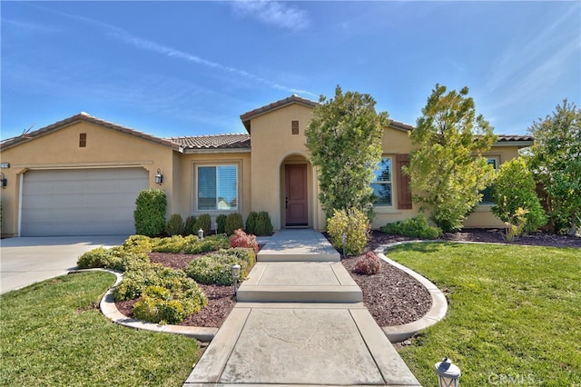 mediterranean / spanish-style house featuring a garage, a tile roof, concrete driveway, stucco siding, and a front lawn