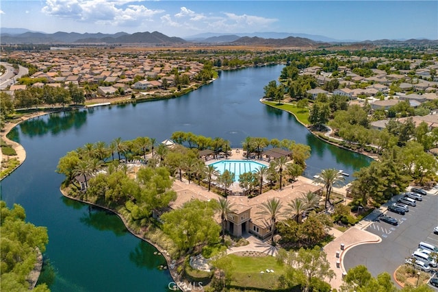 drone / aerial view featuring a water and mountain view