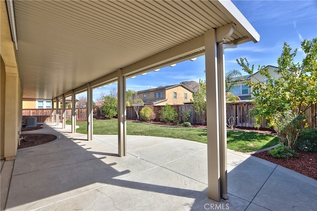 view of patio / terrace featuring a fenced backyard, central AC, and a residential view