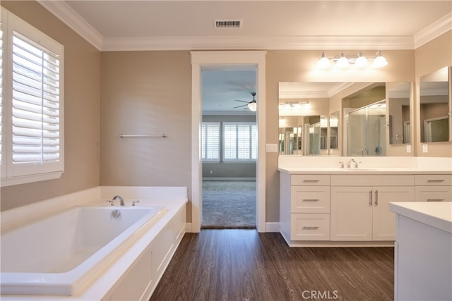 full bathroom with visible vents, crown molding, a bath, and wood finished floors