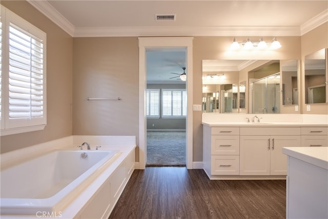 full bath featuring ceiling fan, a bath, visible vents, wood finished floors, and ornamental molding