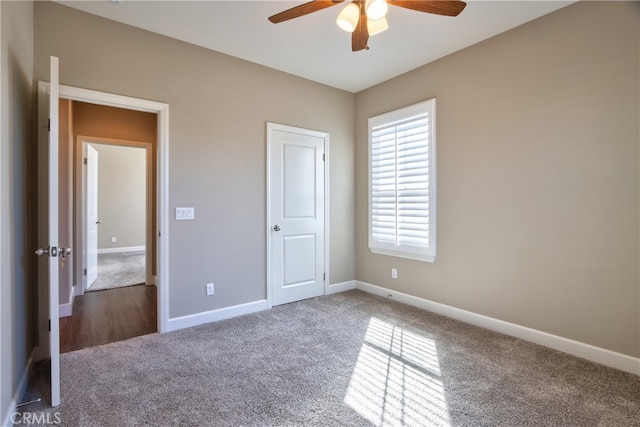 unfurnished bedroom featuring a ceiling fan, baseboards, and carpet flooring