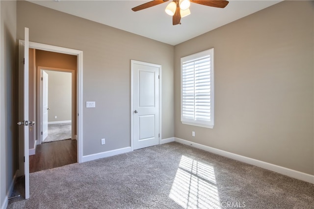 unfurnished bedroom with baseboards, a ceiling fan, and carpet flooring