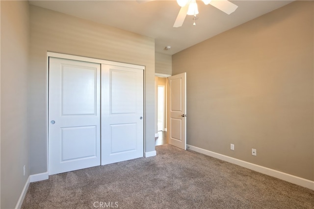 unfurnished bedroom with a closet, baseboards, ceiling fan, and carpet flooring