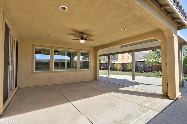 view of patio with fence and a ceiling fan