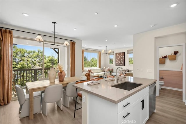 kitchen with a sink, dishwasher, light wood-style floors, and recessed lighting