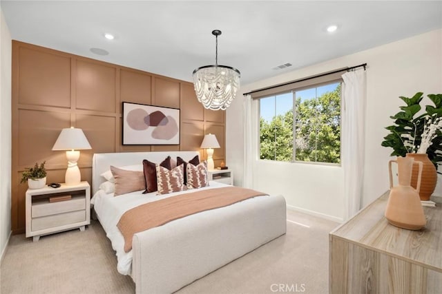 bedroom with light carpet, baseboards, a chandelier, a decorative wall, and recessed lighting