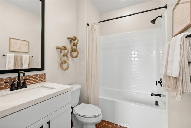 bathroom featuring toilet, tasteful backsplash, vanity, and shower / tub combo