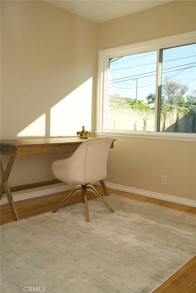 office with baseboards and wood finished floors