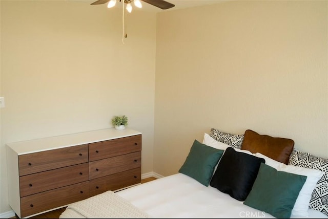 bedroom featuring baseboards and a ceiling fan