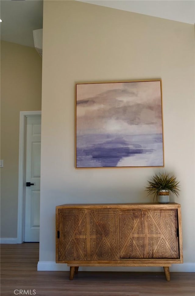 room details featuring baseboards and wood finished floors