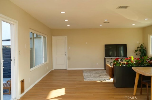 interior space with light wood-type flooring, visible vents, and recessed lighting