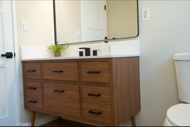 half bath with vanity and toilet