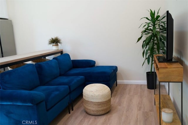 living room with baseboards and wood finished floors