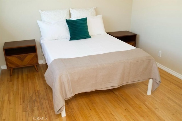 bedroom featuring light wood-style flooring and baseboards