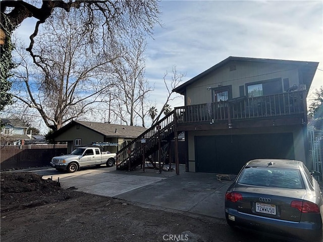 view of front of house with a garage, stairway, and concrete driveway