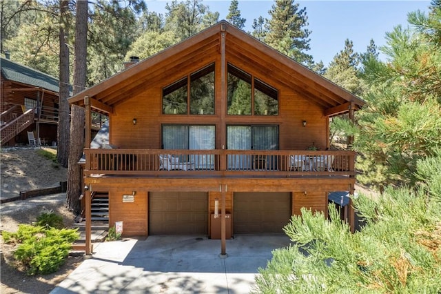 view of front of home with a garage, driveway, and stairway