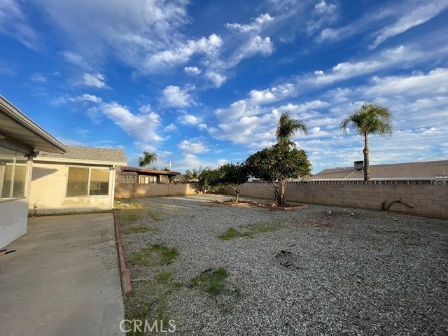 view of yard featuring a fenced backyard and a patio