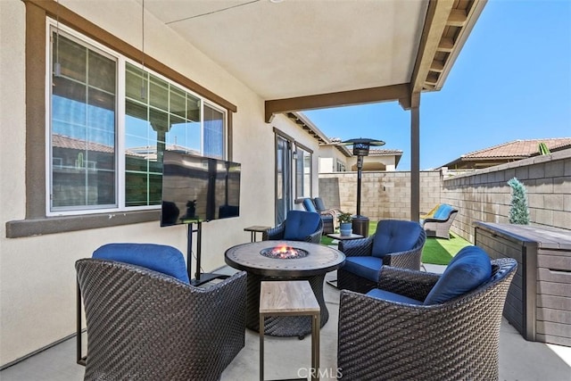 view of patio with a fenced backyard and an outdoor fire pit