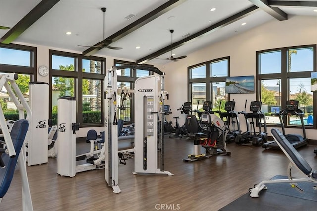 workout area with ceiling fan, a high ceiling, wood finished floors, and recessed lighting