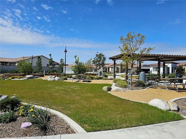 surrounding community featuring a pergola and a yard