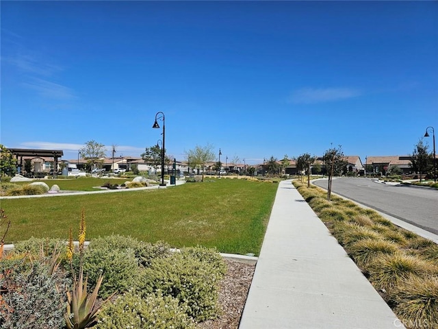 view of community featuring a lawn and a residential view