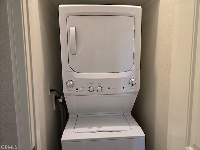 laundry area with stacked washer and clothes dryer and laundry area