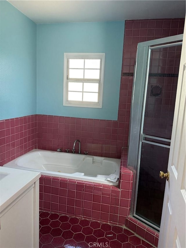 bathroom with a stall shower, tile patterned floors, a bath, and vanity