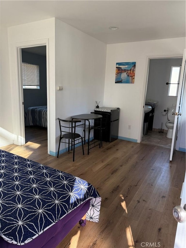 bedroom featuring baseboards and wood finished floors