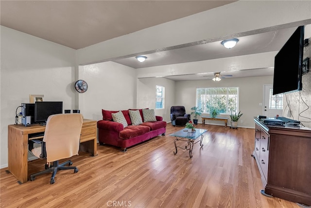 office area featuring baseboards, light wood finished floors, and ceiling fan