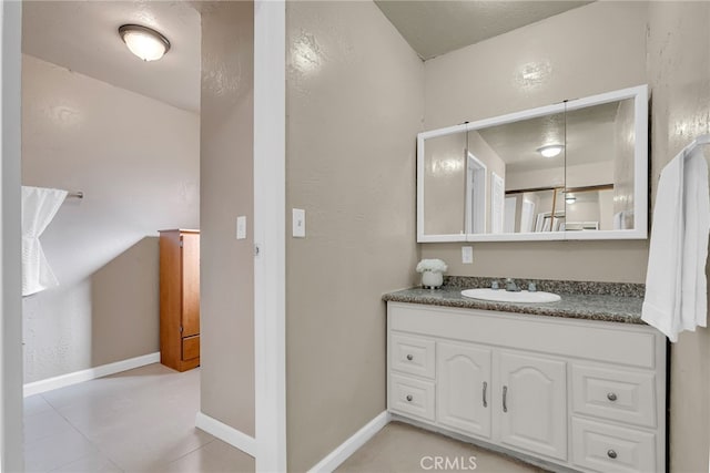 bathroom featuring vanity and baseboards