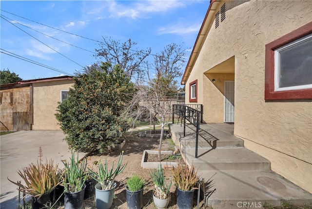 exterior space featuring a garden, a patio, and fence