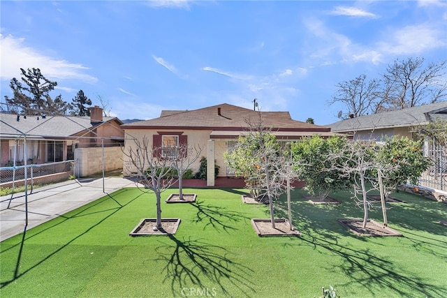 rear view of house featuring a patio area, stucco siding, fence, and a lawn