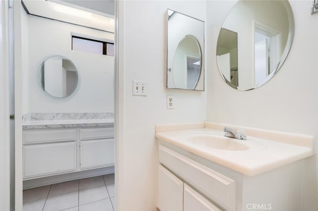 bathroom with tile patterned floors and vanity