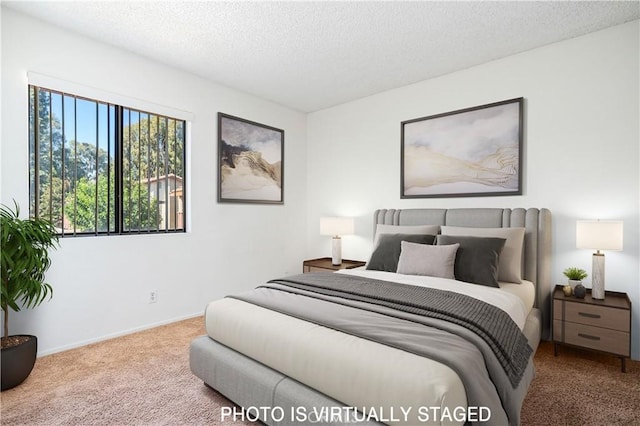 carpeted bedroom with a textured ceiling and baseboards