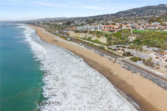 aerial view with a water view and a view of the beach