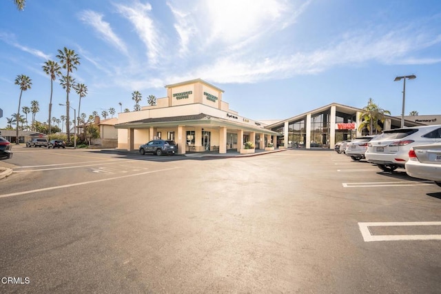 view of building exterior featuring uncovered parking