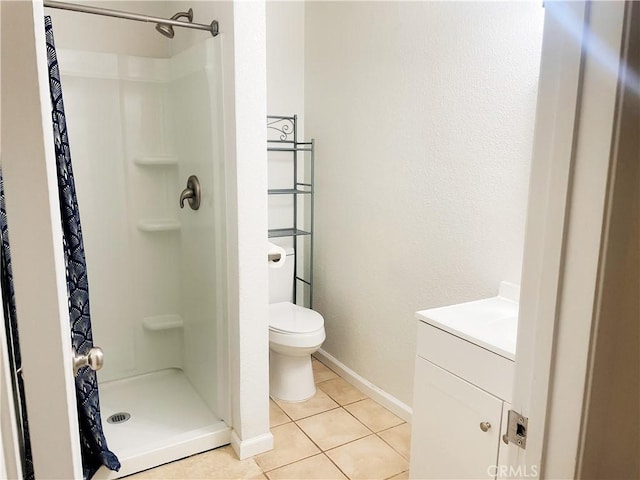 full bathroom with baseboards, toilet, tile patterned floors, vanity, and a shower stall